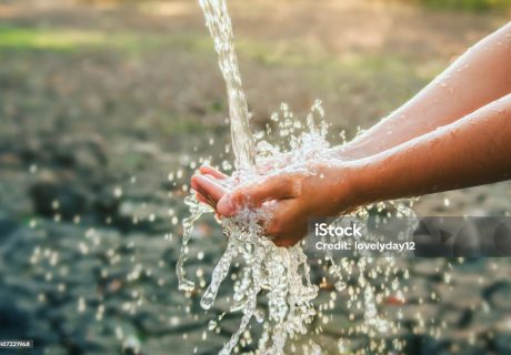 Water pouring on hand in morning ligth background